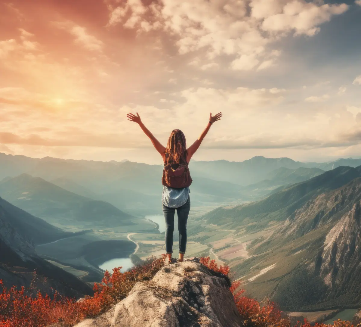 Happy slim girl is standing at sunset mountains