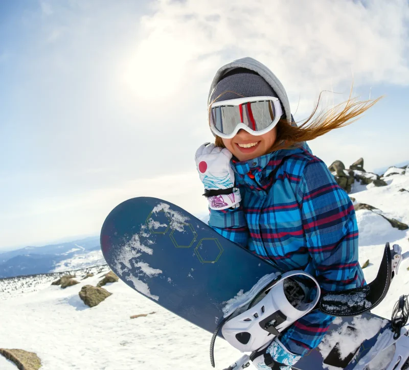 Girl snowboarder enjoys the ski resort